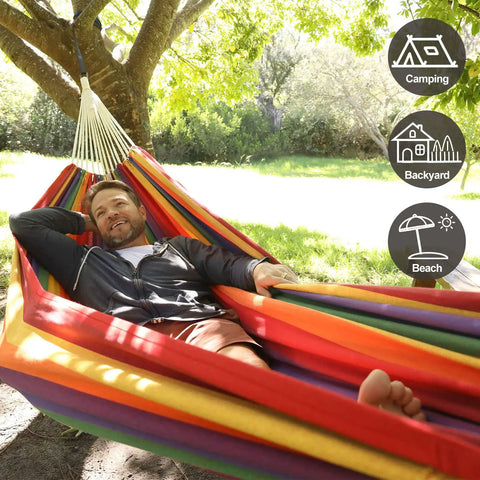 Person lounging in Brazilian Double Hammock For Two People With Tree Straps, Extra Large 240x160 Cm, outdoor setting.