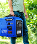 Person holding a blue 3450 Watt Portable Inverter Generator For Camping And RV Use With A 1.6 Gallon Gas Tank, outdoors.