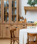 Rustic kitchen with wooden cabinets featuring 10 Pack Matte Black Cup Pulls Three And Three Quarters Inch Hole Center Zinc Alloy Cabinet Handles.