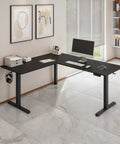 Boss Level L Shaped Electric Standing Desk With Smooth Glide Motors And Three Memory Presets For A Sick Gaming Station Or Remote Work Hub In Sleek Black Finish in modern office setting.