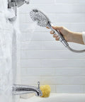 Handheld Shower Kit With 4 Functions, Spectra Plus Spray in use, ergonomic grip, 59-Inch Metal Hose, attached to shower arm, spraying water
