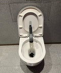 Beast Mode Heavy Duty Toilet Plunger in white toilet, stainless steel high-pressure plunger with real-time pressure display, gray.