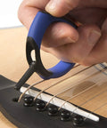 Premium Acoustic Guitar Bridge Pin Puller being used to safely lift a bridge pin on an acoustic guitar.