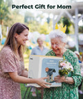 Two women outdoors smiling with a gift box of a Solar Powered Smart Bird Feeder With Camera AI Species ID 8MP Photos And 4K Ultra HD Video Live Stream For Outdoors Must Have Gift For Bird Lovers Easy Setup And Durable Green Feeder.