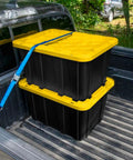 Black truck bed with secured 4 Pack 27 Gallon Heavy Duty Industrial Storage Tote With Lids, Stackable Plastic Bins In Black And Yellow.
