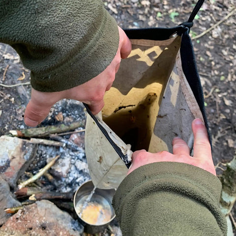 Person using the Water Filtration Bag For Bushcraft And Military Use, Second Edition With Taped Seams, Handmade In The UK outdoors.