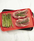 Grilling Prep And Serve Trays Set 17 x 10.5 Inch Dual Nesting Trays Red For Raw Meat And Black For Cooked Food on counter