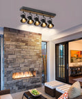 Installed five light adjustable track lighting fixture in industrial black for ceiling in modern home living space.