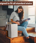 Woman playing guitar near stair basket organizer for carpeted and wooden stairs foldable 16L x 10W x 16H with sturdy handles.