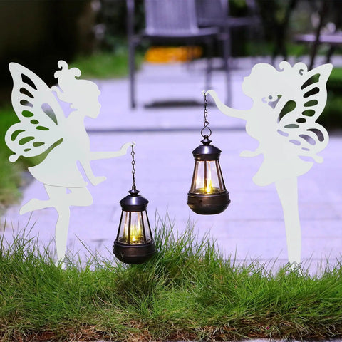 2 Pack Metal Fairy Hanging Lantern Solar Outdoor Garden Stakes with Silhouette Lights in nighttime garden setting