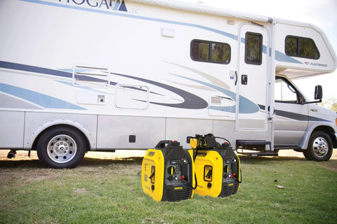 2500 Watt Dual Fuel Portable Inverter Generator With Quiet Technology and CO Shield next to RV on grass