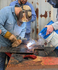 Worker using Tartan AAA Welding Electrode One Eighth Inch Diameter For Mild Steel Repairs in outdoor welding demonstration