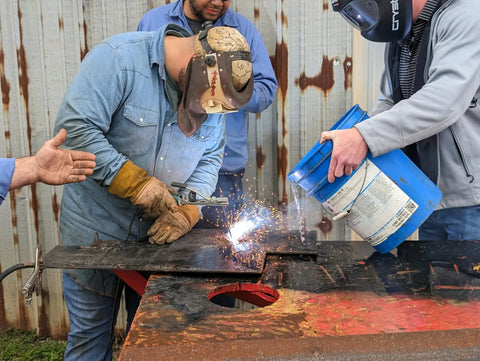 Worker using Tartan AAA Welding Electrode One Eighth Inch Diameter For Mild Steel Repairs in outdoor welding demonstration
