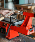 Woodturning on lathe with 12 Inch Heavy Duty Extension Bed for 32 Inch reach, compatible with 14x20 midi lathes, painted red.