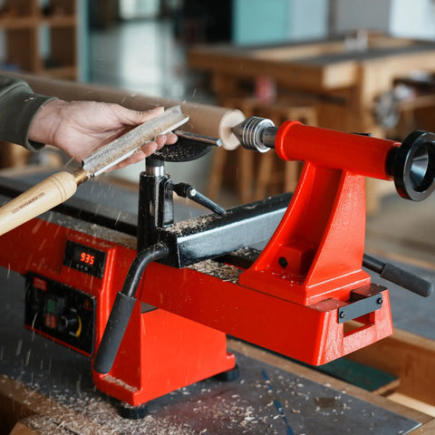 Woodturning on lathe with 12 Inch Heavy Duty Extension Bed for 32 Inch reach, compatible with 14x20 midi lathes, painted red.