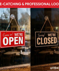 Double-sided open and closed sign for biz with twine and suction cup, showing 'Open' on left and 'Closed' on right on window
