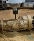 Close-up of CNC V-bit engraving tool cutting a wooden statue; carbide tip, 0.1 mm, 1/8 in shank.
