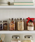 Shelf with wide-mouth jars using stainless steel one piece mason jar lids, filled with pantry items, showcasing airtight seal, rust-resistant features.