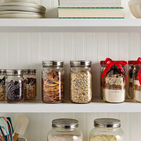 Shelf with wide-mouth jars using stainless steel one piece mason jar lids, filled with pantry items, showcasing airtight seal, rust-resistant features.