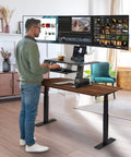 Avlt Electric Standing Desk Converter Fits Triple 32 Inch Monitors in use, showing ergonomic sit-stand height adjustment.