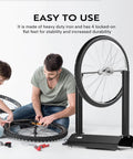 Motorcycle Wheel Balancer For Most Motorcycles And Sport Dirt Bikes With Adjustable Centering Cones, black iron frame, in use.