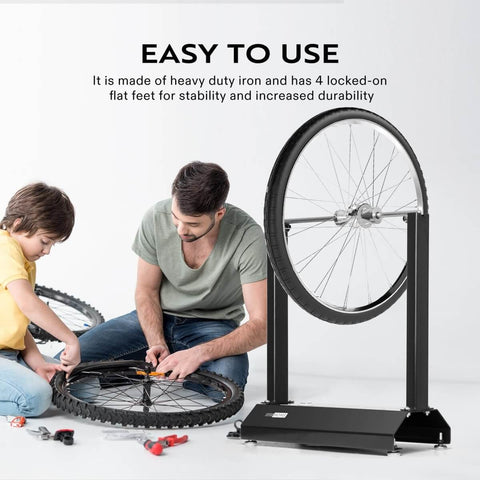 Motorcycle Wheel Balancer For Most Motorcycles And Sport Dirt Bikes With Adjustable Centering Cones, black iron frame, in use.