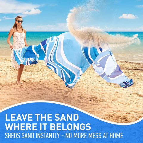 Woman shaking sand off Waterproof Beach Blanket Sandproof 128 By 108 Inch Big Ol Portable Picnic Mat at the beach
