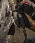 Compact Right Angle Pneumatic Die Grinder With 1/4 Inch Collet And 20000 Rpm Motor used for polishing a car panel in an auto shop.