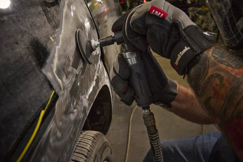 Compact Right Angle Pneumatic Die Grinder With 1/4 Inch Collet And 20000 Rpm Motor used for polishing a car panel in an auto shop.