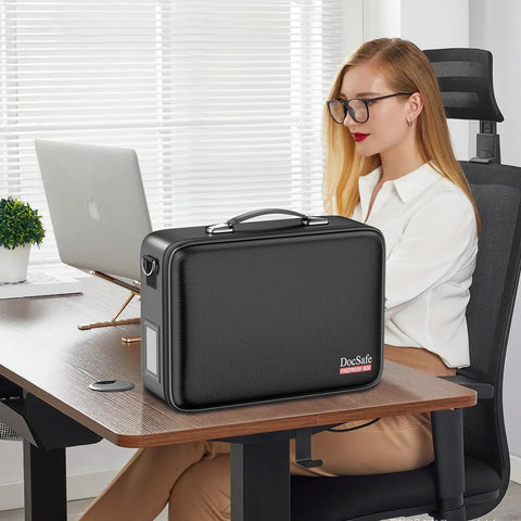 Fireproof Document Box With Lock And Shoulder Strap on a desk, hard shell case file organizer with accordion folders visible in an office.