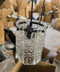 3 Pack Water Ripple Glass Pendant Lights Kitchen Island, close-up of clear glass shade and black mounting in warehouse setting.