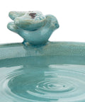 Close-up of turquoise ceramic bird figurine on a 25 Inch Tall Outdoor Ceramic Antique Pedestal Birdbath with water ripples.