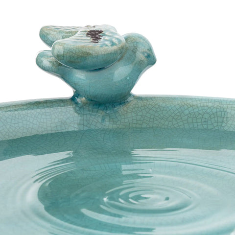 Close-up of turquoise ceramic bird figurine on a 25 Inch Tall Outdoor Ceramic Antique Pedestal Birdbath with water ripples.