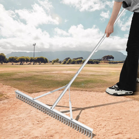 Person using Aluminum Maintenance Rake With Adjustable 66 To 98 Inch Handle on a baseball field; 36 inch head, rustproof aluminum.