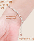 Allergy-free bracelet with silver double lobster claw clasps extending length and secure welded closing rings on wrist.