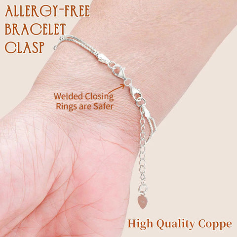 Allergy-free bracelet with silver double lobster claw clasps extending length and secure welded closing rings on wrist.