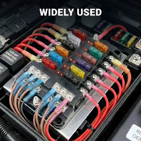 Close-up of a fuse box with Marine Grade Heat Shrink Ring Terminal Kit 112 Pcs installed, showing colored crimp connectors in use.