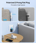 Two Prong Power Strip With Five Foot Cord 1440J Surge Protector Eight In One Charging Station Featuring Four 3 Prong Outlets And Four USB Ports Non Grounded Polarized Plug Wall Mount Ready Old House Friendly White, shown in use behind a couch.
