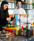 Grill Caddy With Paper Towel Holder And Seven Compartment Organizer For Outdoor BBQs on a kitchen counter with spices and utensils