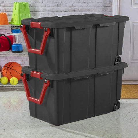 Two Pack 160 Quart Black Stackable Rolling Storage Bins with Heavy Duty Red Latches and Smooth Glide Wheels for Garage Organization.