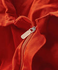 Heavy Duty Metal Zipper Pull Tabs Replacement Set With Super Straightforward Tool Free Install For Jacket Fixes Clothing Repairs On Red Fabric.