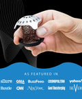 Hand holding Ultra Tub Drain Protector Hair Catcher Kit Stainless Steel Tub Strainer Snare against black background.