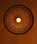 Bottom view of Bamboo Pendant Light Fixture Black Finish, Boho Rattan Woven Hanging Lamp For Kitchen Island Or Nursery lit up