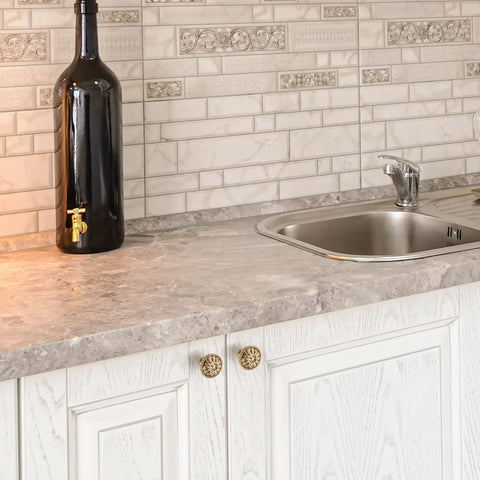 15 Pack One And One Fifth Inch Rustic Champagne Bronze Dope Finish Kitchen Cabinet Knobs And Drawer Handles visible on white cabinet