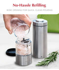 Battery Operated Salt And Pepper Grinder Set With Light Stainless Steel Mills being refilled with pink Himalayan salt