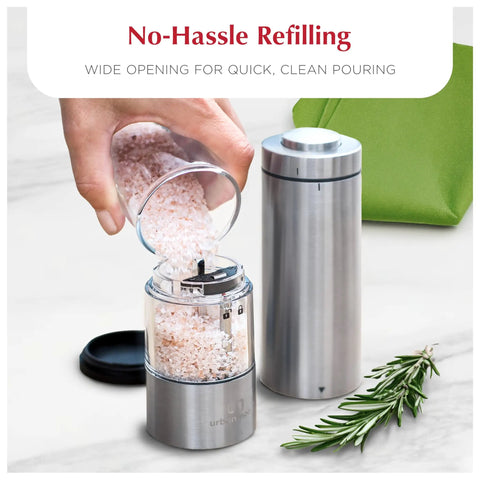 Battery Operated Salt And Pepper Grinder Set With Light Stainless Steel Mills being refilled with pink Himalayan salt
