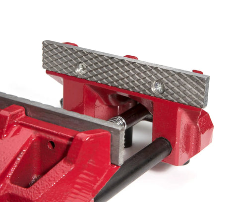 Close-up of the Low Profile 6 Inch Bench Vise with Rapid Opening Rugged Steel Jaws, showing replaceable serrated jaws.