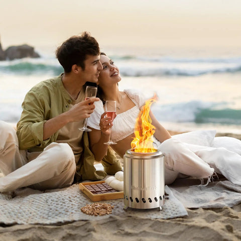 Couple on beach using Tabletop Fire Pit Mini Portable Outdoor Smokeless Firepit Stainless Steel 5.5 Inch Tabletop Fire Pit