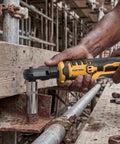 Cordless Three Eighth Inch Ratchet Wrench Packing Eighty Eight Foot Pounds Of Real Deal Power Running Smooth At Five Hundred Rpm Compatible With Dewalt Twenty Volt Batteries For Auto Shop Grind Or Weekend Mechanic Jobs Tool Only No Battery Included in use tightening a bolt on a metal frame.