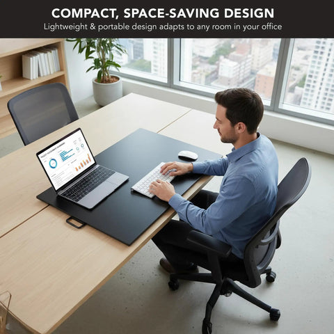 Man working at 32 by 22 inch standing desk converter with gas spring lift, showing ergonomic height adjustable workstation in office.